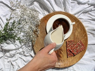Pouring milk in a coffee