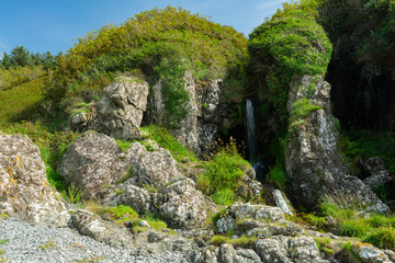 Fototapeta na wymiar Waterfall on Port Mora beach, Scotland