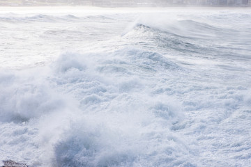 Foamy stong waves crashing in the ocean