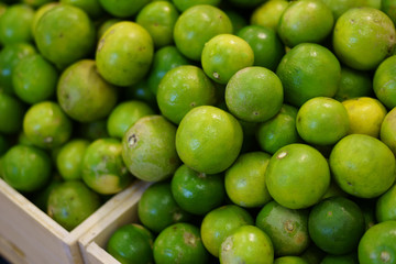 Tropical lime fruit on greengrocery fruit shop