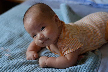baby boy lay on the bed