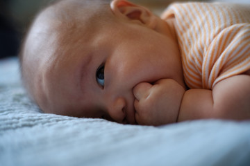 baby boy lay on the bed