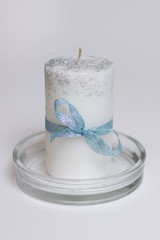 white candle with a bouquet of dried flowers