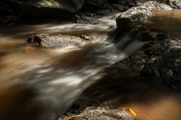 Water flows through the rocks on the mountain.