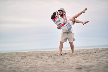 Romantic happy couple on the beach; Newlyweds concept