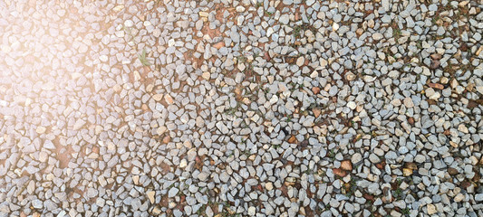 The surface of the walkway is filled with small rocks.