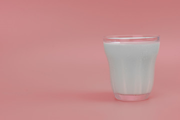 Fresh Milk in glass with copy space on pink background
