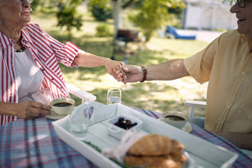 Grow old together.Senior couple hold hands and enjoying together outdoor.