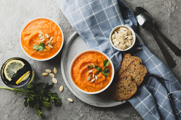 Composition with pumpkin soup on gray background, top view