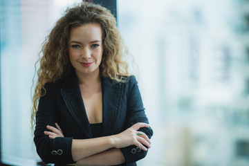 Fototapeta na wymiar portrait of business woman with golden curly hair in a suit