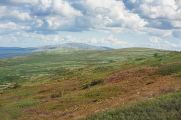 Fototapeta na wymiar Scenic view of beautiful landscape with tundra hills and sky clouds
