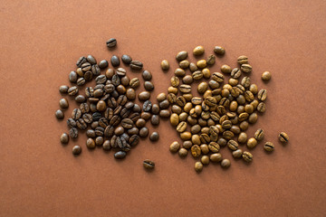 Coffee beans on brown background close up