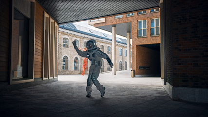 Handsome Man in Spacesuit is Dancing in a Neighbourhood. Astronaut is Happy and Makes Creative...