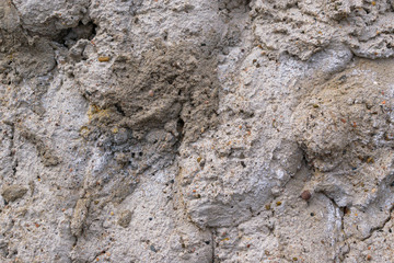 Concrete wall for the backdrop. Small stones, influx, cracks.