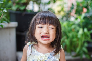 Portrait image of 2-3 years old baby girl. Asian child girl crying when she playing with the toy at the playground. Expression and emotions of baby concept.