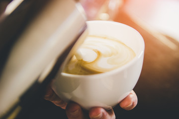 Hand on Barista making latte cafe