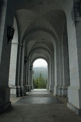 Fototapeta premium Architecture. Empty exterior corridor, concrete archway and columns in the closed Valley of the Fallen, Spain, due to coronavirus pandemic. 