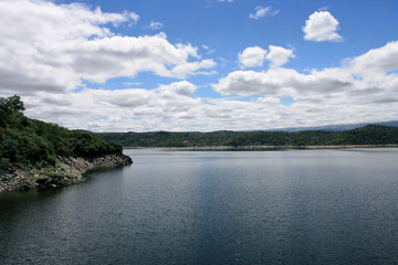 Vacations. Aerial view of the pure water lake, shoreline and forest in a summer sunny day. 