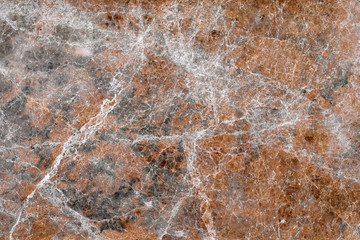Reddish marble tile wall backdrop.