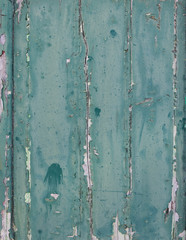 vertical planks with peeling blue green paint