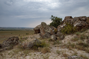 Fototapeta na wymiar rocky steppe landscape on the background of a cloudy sky with clouds