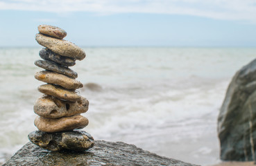 Fototapeta na wymiar Stack of round smooth stones on a seashore