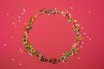 Christmas wreath from star sparkles on red