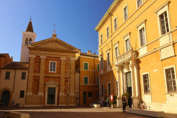 Fototapeta na wymiar Pesaro, little square with church and coloured houses
