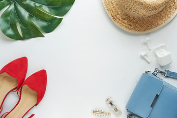 Summer outfit. Brown cross bag, headphones, straw hat. Flat lay, top view. Female, summer street style. Women's frame of accessories.