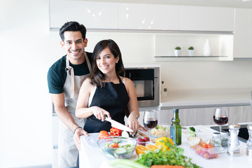Happy Couple Preparing Food Together At Home