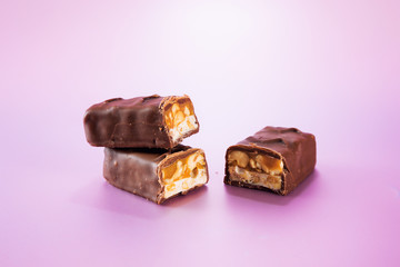 Chocolate bars isolated on colorful background.