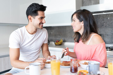 Obraz na płótnie Canvas Happy Hispanic Couple Having Breakfast Together