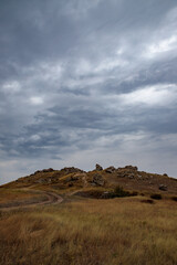 rocky steppe landscape on the background of a cloudy sky with clouds