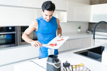 Latin Man Preparing Healthy Shake In Kitchen