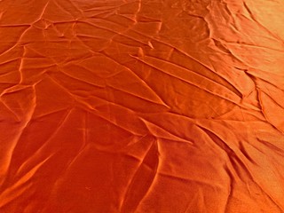 Orange cloth background full of creases