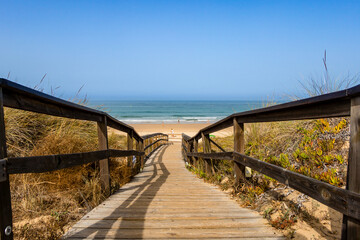 Wooden walkway that gives access to La Barrosa beach in Sancti Petri, Cadiz