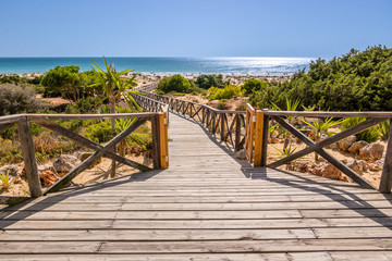 Wooden walkway that gives access to La Barrosa beach in Sancti Petri, Cadiz