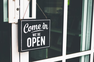 Come in we're open, vintage retro sign on cafe door