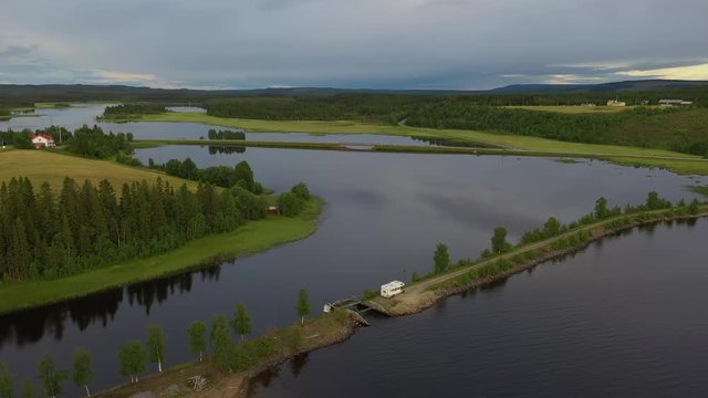 Aerial view of an RV parked on a land tongue in northern Sweden