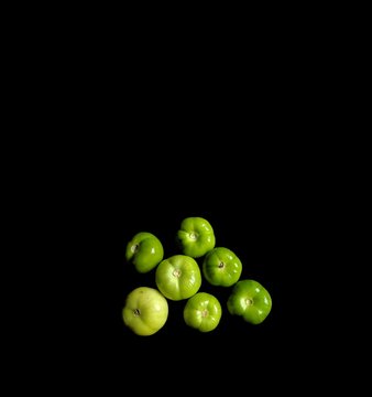 Miltomate or green tomato on black background. typical Guatemalan vegetable