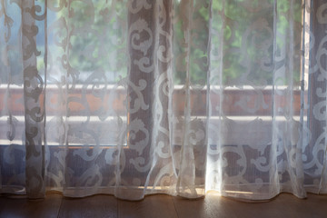 tulle curtains for the window with access to the terrace