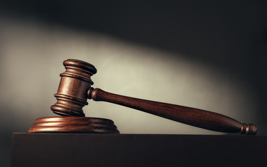 Judge (auction) gavel on the background of a beam of light