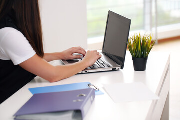 Young pretty business woman with notebook in the office