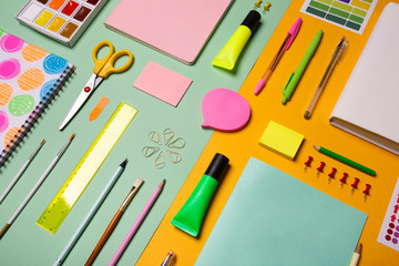 School tools and accessories on yellow and light green background