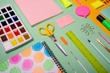 School tools and accessories on yellow and light green background