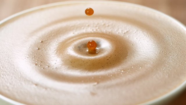 Falling sugar cane into coffee cup, super slow moton at 1000 fps.