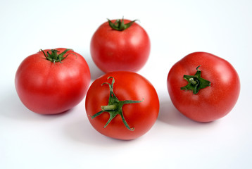Juicy ripe tomatoes on a white background.