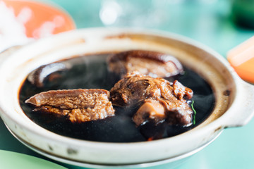 ceramic bowl with soup with meat in it