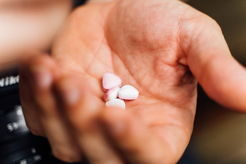 Closed hand showing some pills