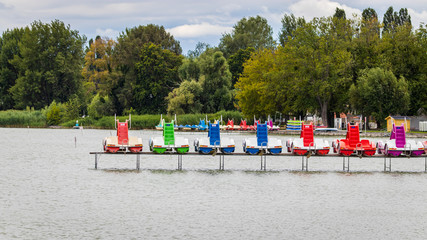 Fototapeta na wymiar Colorful pedal boats on a pier in Lake Balaton